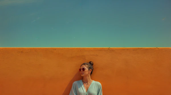 Serene Woman against Vibrant Orange Wall