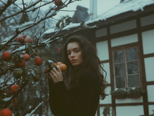 Contemplative Woman in Winter Orchard