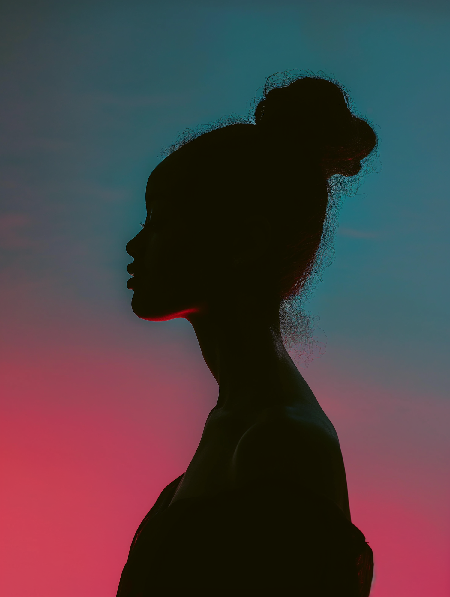 Contemplative Silhouette Against Blue-Pink Gradient