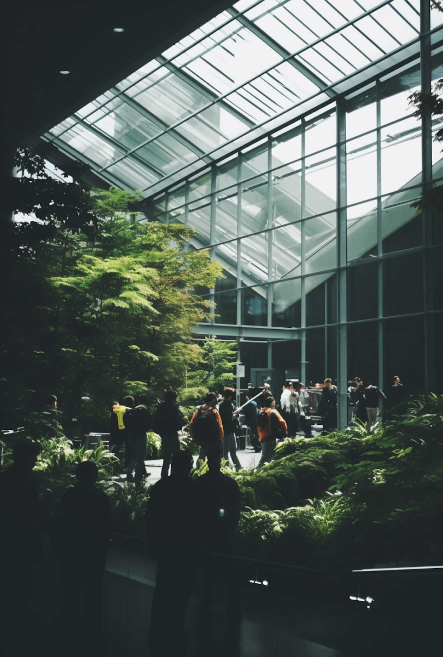 Modern Atrium with Indoor Garden and Silhouetted Figures