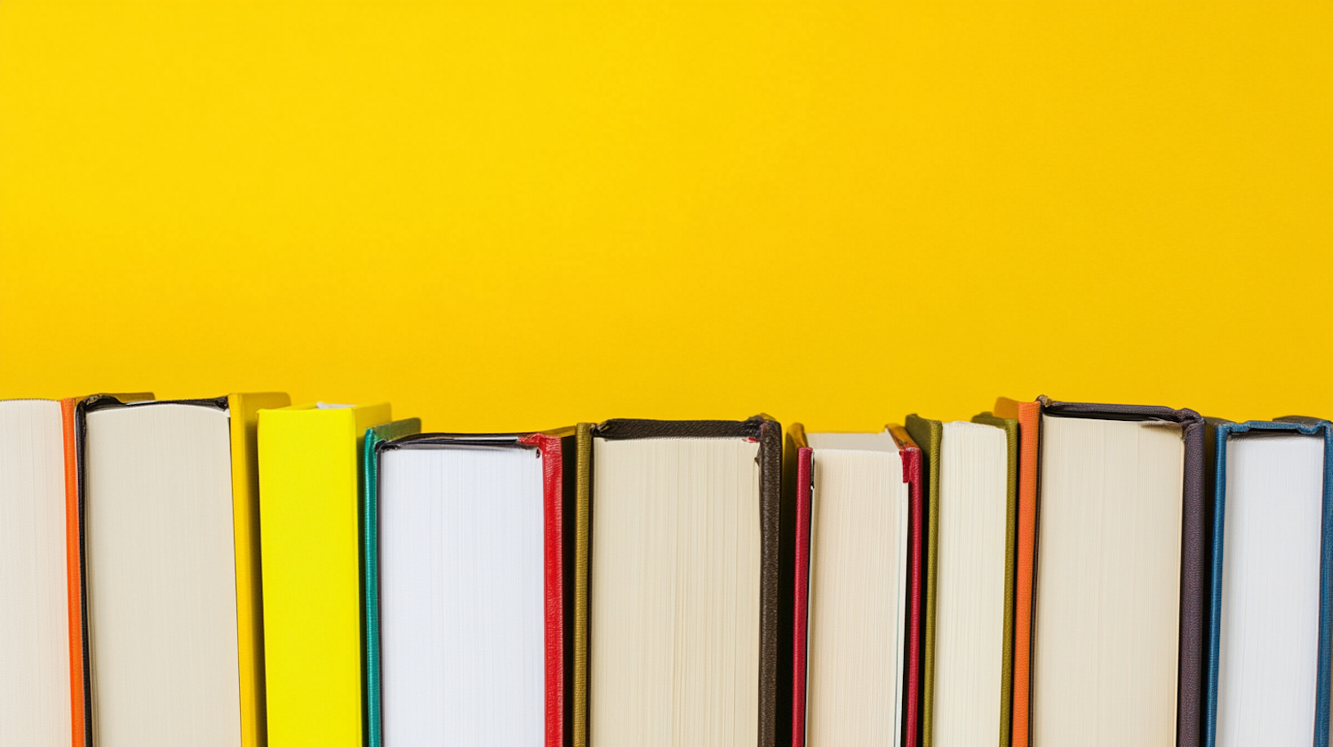 Colorful Books Against Yellow Background