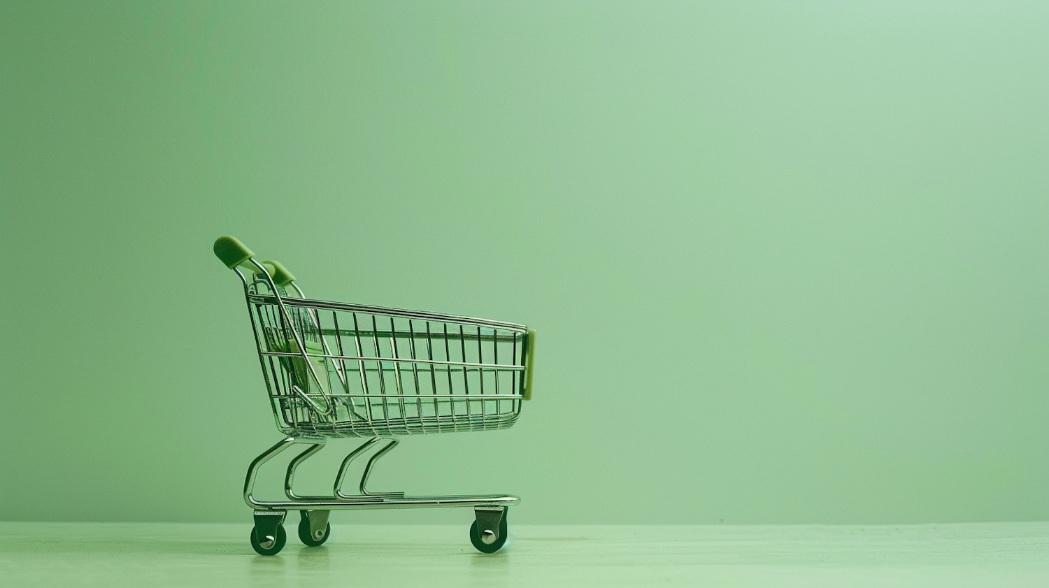 Minimalist Miniature Shopping Cart on Pale Green Background