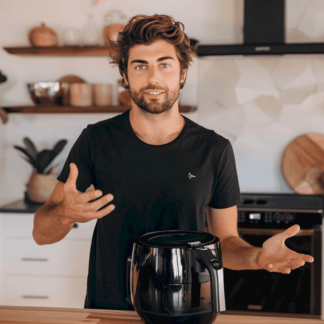 Man Demonstrating Air Fryer in Kitchen