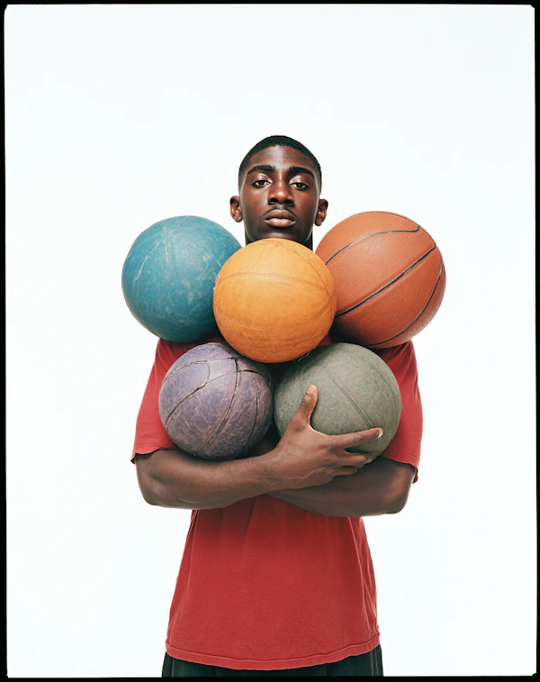Man Holding Basketballs
