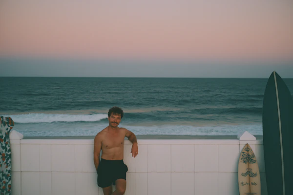 Man by Beach Fence