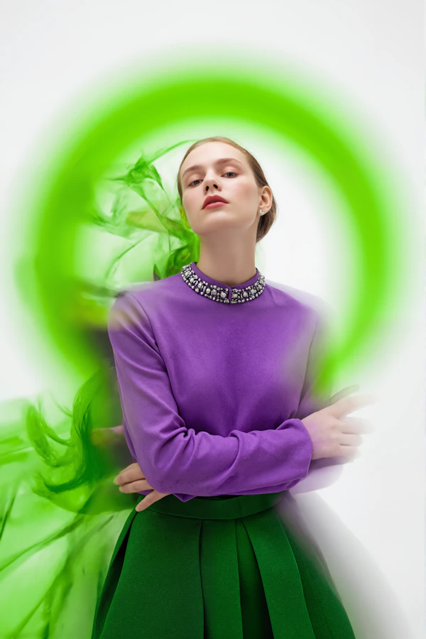 Woman in Vibrant Outfit with Green Swirling Effect