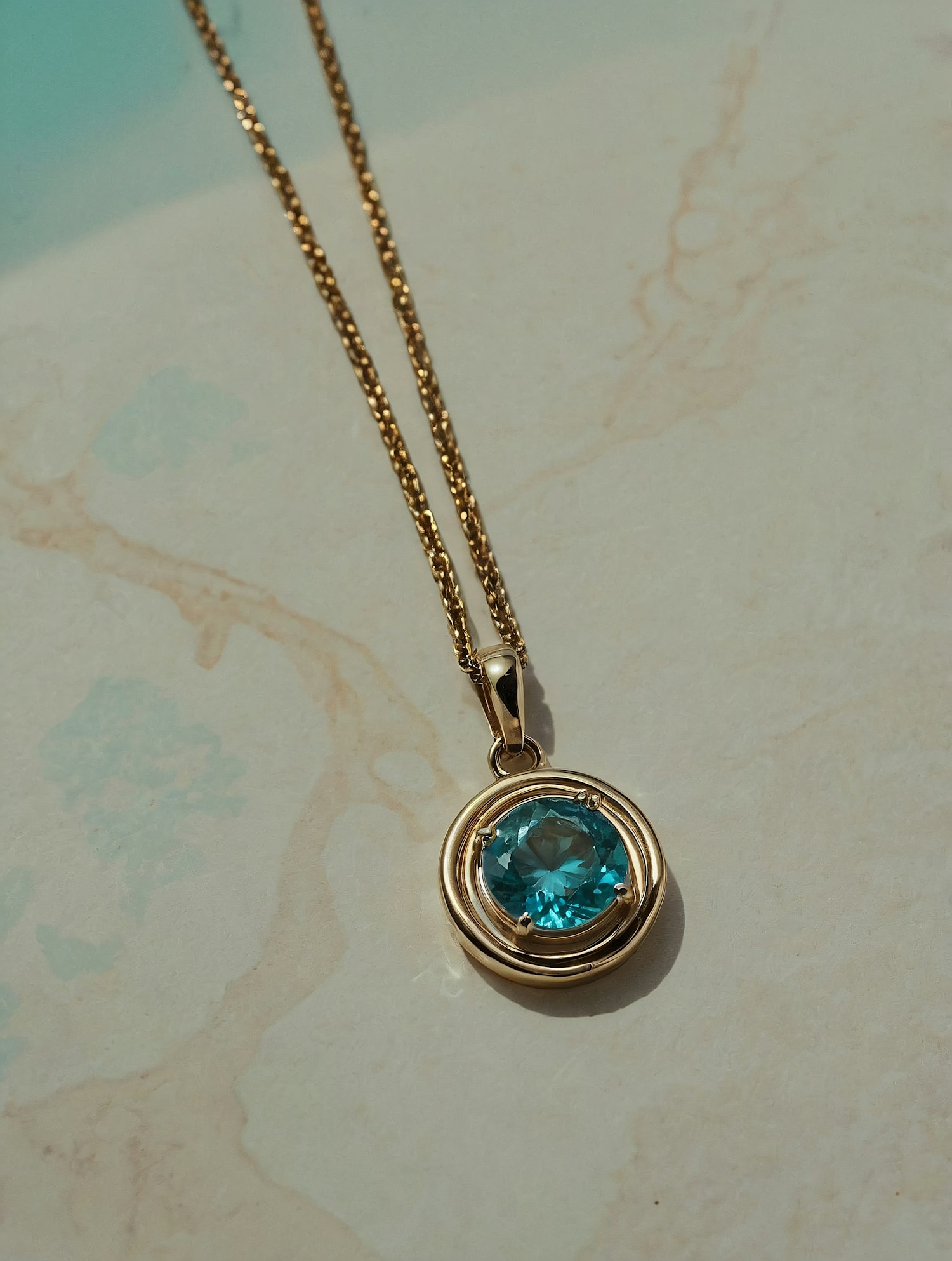 Gold Necklace with Blue Gemstone Pendant