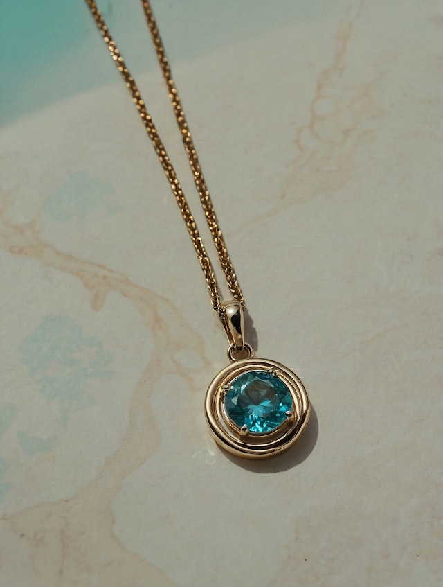 Gold Necklace with Blue Gemstone Pendant