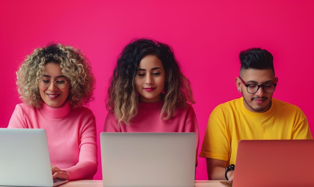 Three Adults Working on Laptops