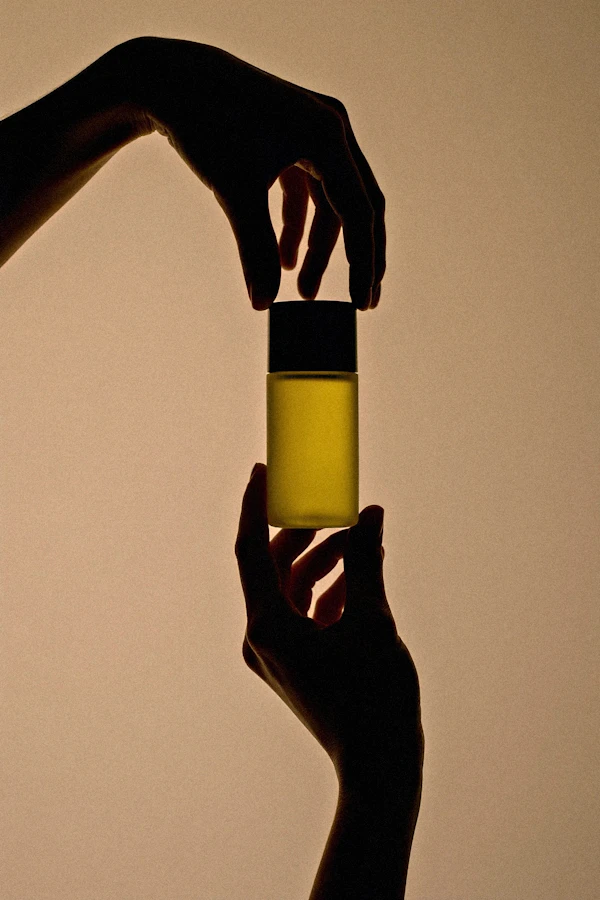 Hands Holding Bottle