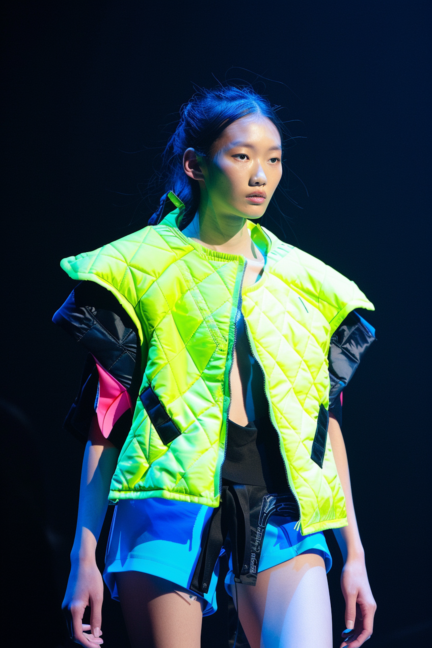 Asian Woman in Neon Green Jacket on Stage