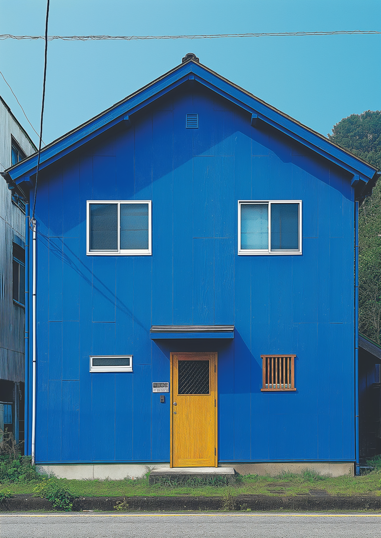 Vivid Blue Two-Story House with Yellow Door