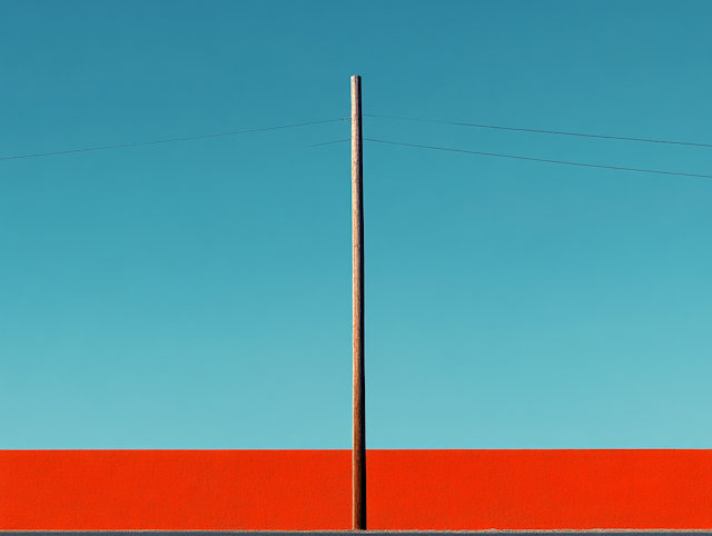 Minimalist Utility Pole Against Blue Sky