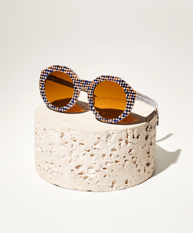 Checkered Pattern Sunglasses on Stone Pedestal