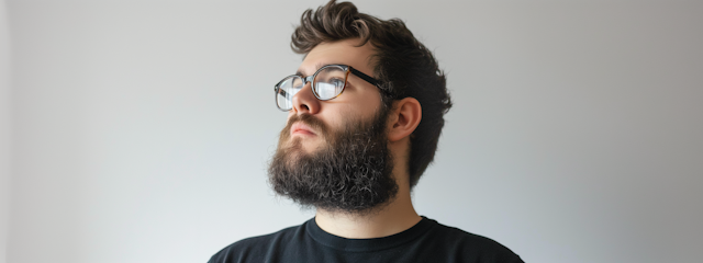 Thoughtful Bearded Man with Glasses