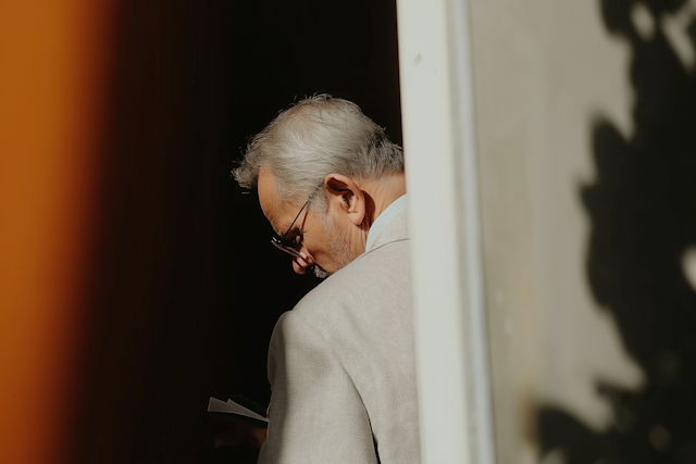 Introspective Older Man in Light Suit