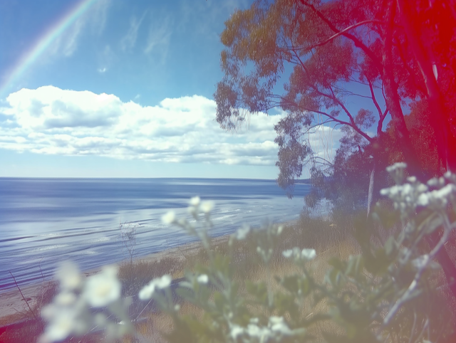 Serene Coastal Landscape with Rainbow