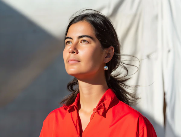 Contemplative Woman in Red Shirt Outdoors