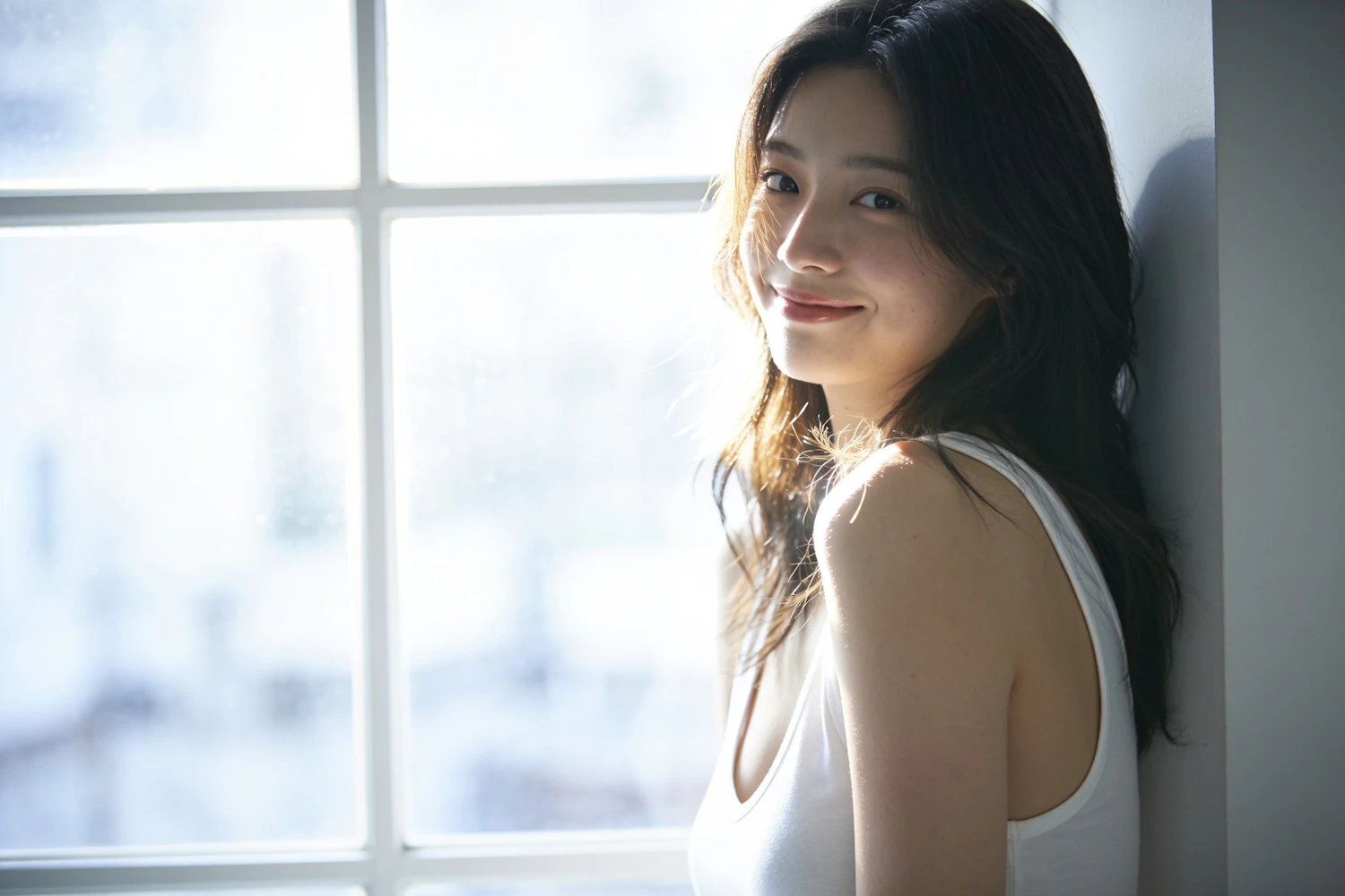 Elena Marsh smiling softly beside a sunlit window