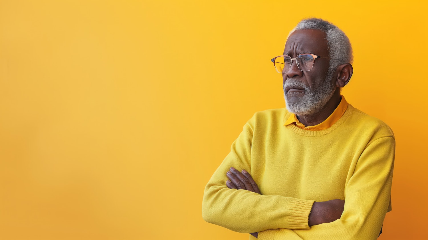 Contemplative Elderly Man Against Yellow Background