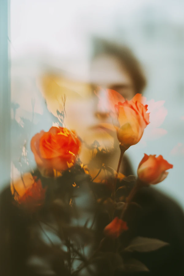 Blurred Human with Vibrant Orange Roses