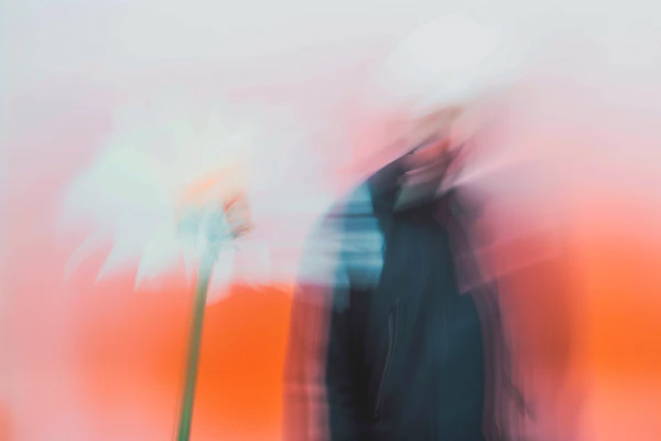 Blurred Person & Flower