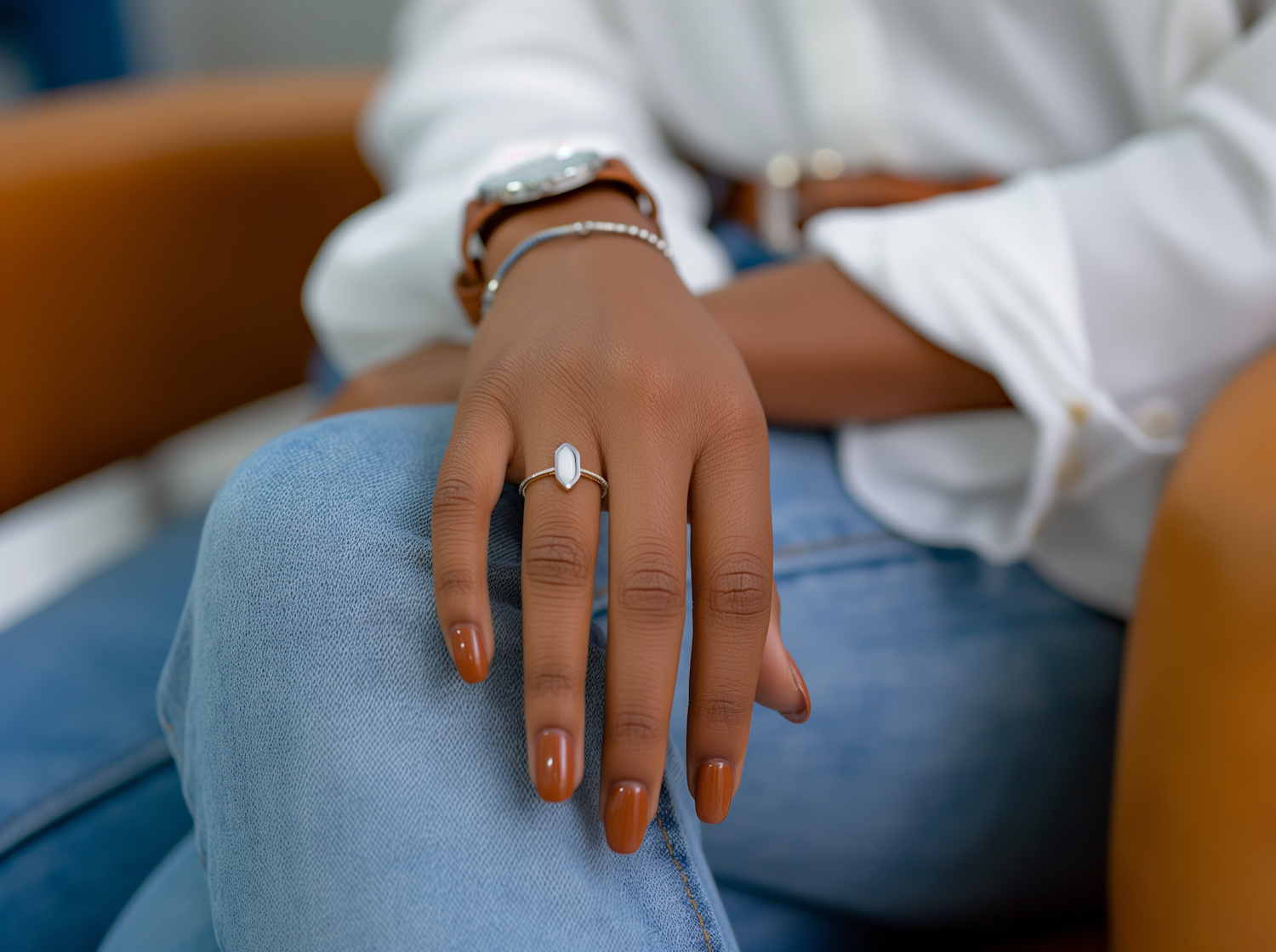 Stylish Woman's Accessorized Hand Resting on Thigh